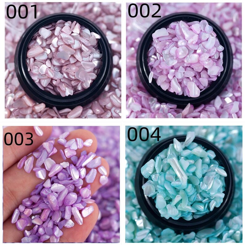 May include: Four images showcasing crushed shell pieces in various colors. The first image displays pink shells in a black container, labeled "001." The second image shows purple shells, labeled "002." The third image features purple shells held in a hand, labeled "003." The fourth image shows blue shells, labeled "004."