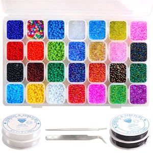 May include: A clear plastic storage box filled with 24 small containers of colorful seed beads. The box is open and the beads are visible. There are two spools of string and a pair of tweezers next to the box.