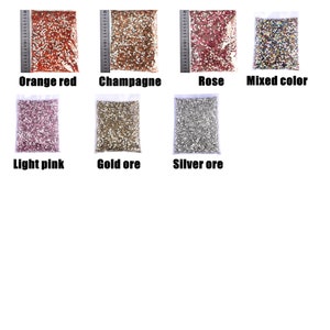 May include: Assortment of small, colorful, sparkly beads in clear plastic bags. The bags are labeled with the color of the beads: Orange red, Champagne, Rose, Mixed color, Light pink, Gold ore, and Silver ore.