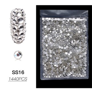May include: A clear plastic bag filled with small, round, clear rhinestones. The rhinestones are in various sizes and are perfect for nail art, crafts, and jewelry making. The bag also includes a close-up image of a single rhinestone and a larger image of rhinestones arranged in a cluster. The text "SS16 1440PCS" is printed below the images.