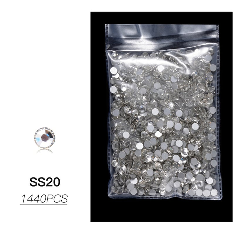 May include: A clear plastic bag filled with small, clear rhinestones. The bag is labeled "SS20 1440PCS".