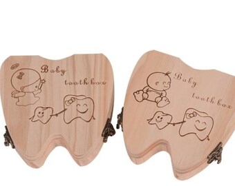 May include: Two wooden tooth boxes shaped like a tooth. Each box has a different design of a baby and a tooth. The text on the boxes reads "Baby tooth box".