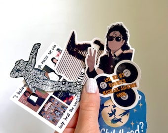 May include: A collection of vinyl stickers featuring Michael Jackson imagery, including a silhouette filled with song titles, a portrait with sunglasses, a record-shaped sticker with the text Ask Me My Favorite Michael Jackson Song, and a blue sticker with the text Childhood.