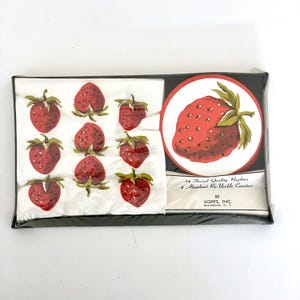 May include: A rectangular package containing 14 facial quality napkins and 4 absorbent re-usable coasters by Sopps, Inc. Brooklyn, N.Y. The napkins feature a repeating red strawberry pattern on white, while the coasters display a large strawberry.