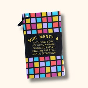 May include: A rectangular coloring book with a black ring binder at the top left. The cover features a grid of colorful squares in red, yellow, blue, and purple. The text reads: MINI MENTY B A COLORING BOOK FOR FOLKS WHO ARE EXHAUSTED & DON'T HAVE TIME FOR A FULL MENTAL BREAKDOWN.