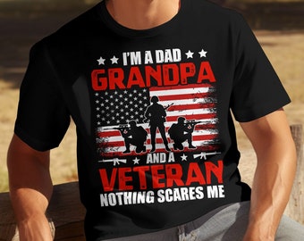 May include: Black t-shirt featuring the text "I'M A DAD GRANDPA AND A VETERAN NOTHING SCARES ME." The design incorporates an American flag and soldier silhouettes. The text is in red and white.