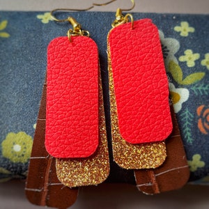 Brown, gold sparkle and red rectangular earrings.