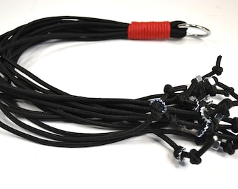 Paracord flogger with soft paracord bound handle, in Black 16 falls 18 inches long. Metal nuts and serrated washers at the end of each fall!