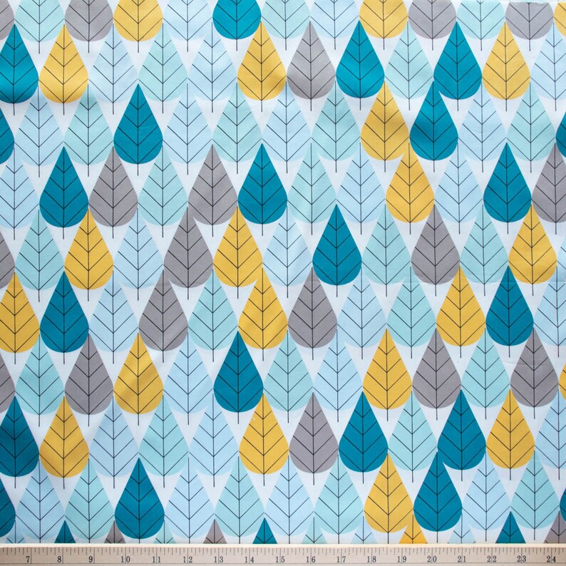 May include: A white fabric with a repeating pattern of teal, gray, and yellow leaf shapes. The leaves are stylized and have a geometric design.