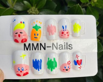 May include: A set of ten white press-on nails with colorful cartoon designs. The designs include a pineapple, a strawberry, a heart, a star, a cloud, and a flower. The nails are labeled "MMN-Nails".