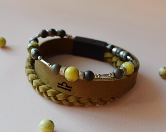 May include: A stacked bracelet set featuring yellow turquoise and striped agate stones. The bracelets are olive green leather with silver accents and a braided design. Text on the image reads "Yellow Turquoise & Striped Agate Stones" and "River Stone Leather Color."