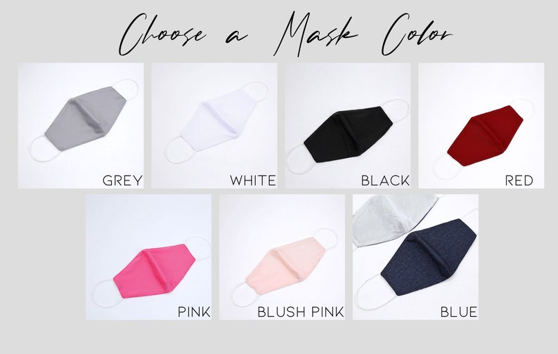 May include: A selection of face masks in various colors, including grey, white, black, red, pink, blush pink, and blue. The masks are all made of fabric and have elastic ear loops.