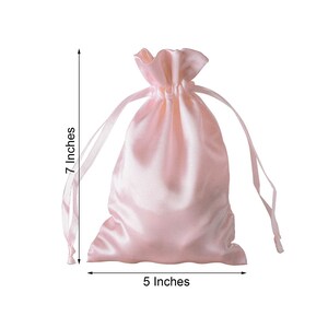 May include: A light pink satin drawstring bag with a 7 inch height and 5 inch width.