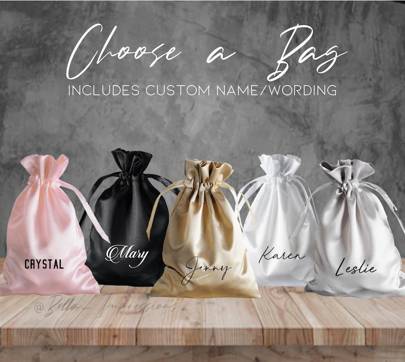May include: Five satin drawstring bags in different colors with personalized names: Crystal, Mary, Jenny, Karen, and Leslie. The bags are arranged on a wooden surface. The text "Choose a Bag" and "Includes Custom Name/Wording" is visible at the top of the image.