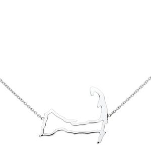 May include: A silver necklace featuring a pendant shaped like the outline of Cape Cod, Massachusetts. The pendant is connected to a delicate chain, creating a minimalist and elegant jewelry piece. The necklace is displayed against a white background.