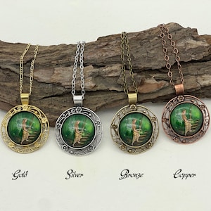 May include: Four necklaces with different colored metal chains and pendants. Each pendant features a round, green glass cameo with a fairy sitting on a stone step in a forest. The necklaces are labeled "Gold", "Silver", "Bronze", and "Copper".