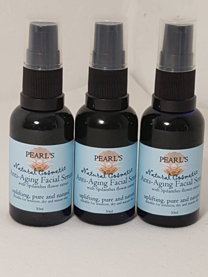 May include: Three dark blue cosmetic serum bottles with black spray tops. Each bottle has a light blue label with the text "PEARL'S Natural Cosmetic Anti-Aging Facial Serum" and other text. The bottles are 30ml each.