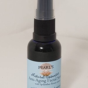 May include: A dark blue glass bottle of Pearl's Natural Cosmetic Anti-Aging Facial Serum. The label is light blue with white text and a seashell graphic. The bottle has a black pump and a clear plastic cap. The bottle contains 30ml of serum.