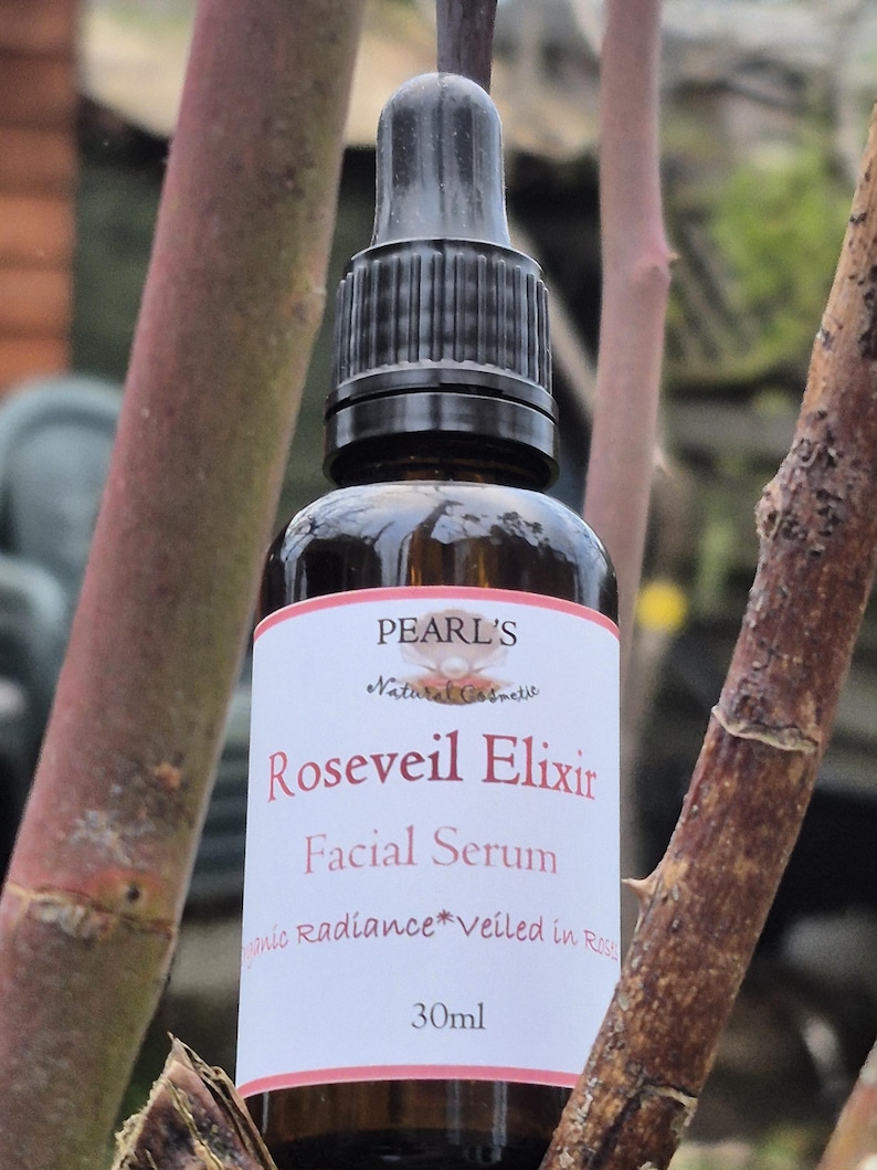 May include: A brown glass bottle of Roseveil Elixir facial serum with a black dropper. The label reads "Pearl's Natural Cosmetic" and "Roseveil Elixir Facial Serum". The bottle contains 30ml of product.