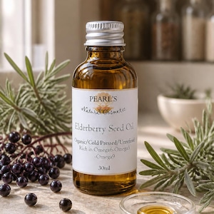 May include: A 30ml amber glass bottle of Pearl's Natural Cosmetic Elderberry Seed Oil with a silver cap. The white label reads Organic/Cold Pressed/Unrefined, Rich in Omega6-Omega3-Omega9. A small glass dish contains golden oil nearby.