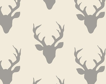 May include: A seamless pattern featuring a repeating design of gray deer heads with antlers on a light beige background.