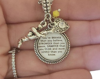 May include: Silver charm necklace with a silver charm that reads "You're BRAVER than you believe, STRONGER than you seem, SMARTER than you think and more LOVED than you know."
