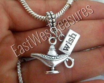 May include: A silver charm necklace with a genie lamp pendant and a small tag that says "wish".