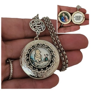 May include: Silver locket necklace with a Winnie the Pooh and Piglet illustration on the front. The locket opens to reveal a space for a photo. The inscription inside reads "The best thing that has ever happened to me is you. Love you forever and always."