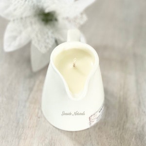 May include: White ceramic pitcher candle with a single wick and the text "Seaside Naturals" on the bottom.