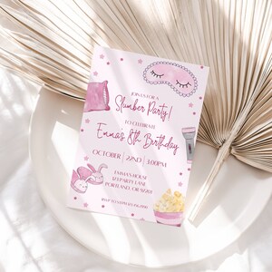 May include: A pink invitation for a slumber party, featuring illustrations of a pillow, sleep mask, flashlight, popcorn, and bunny slippers. The text reads "Join us for a Slumber Party!" to celebrate Emma's 8th Birthday.
