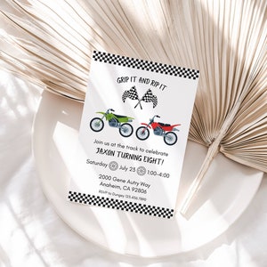 May include: A white birthday party invitation with black and white chequered borders. The invitation features a green and red dirt bike with the text "Grip It and Rip It" and "Jaxon Turning Eight!"  The invitation includes the date, time, and address for the party.