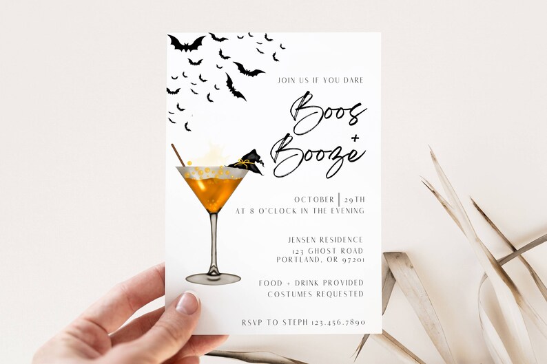 May include: A Halloween party invitation with a black and white illustration of bats flying around a martini glass with a witch's hat on the rim. The text reads "Join us if you dare Boos + Booze October 29th at 8 o'clock in the evening Jensen Residence 123 Ghost Road Portland, OR 97201 Food + Drink Provided Costumes Requested RSVP to Steph 123.456.7890"