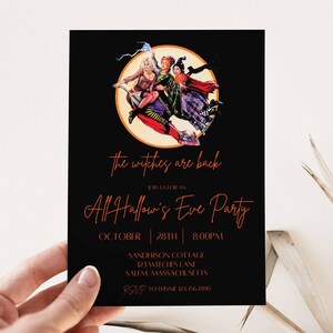 May include: Black invitation card with an image of three witches flying on broomsticks in front of a full moon. The text reads "The witches are back. Join us for an All Hallow's Eve Party. October 28th | 8:00PM. Sanderson Cottage, 123 Witches Lane, Salem, Massachusetts. RSVP to [phone number]"