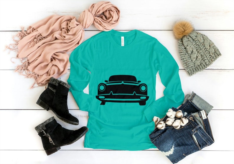 May include: A turquoise long-sleeved shirt with a black silhouette of a classic car on the front.