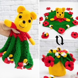 May include: A handmade crochet Winnie the Pooh security blanket with a yellow bear head, red and green body, and bee and flower accents. The blanket transforms into a flower arrangement with bees and red poppies.