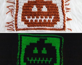 May include: A crocheted pumpkin with a glow-in-the-dark feature. The pumpkin is brown and white in the first image and glows green in the second image.