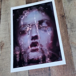 May include: A close-up of a painting depicting a person's face with a distressed, textured effect. The face is partially obscured by a layer of paint, creating a sense of mystery and intrigue. The colors are predominantly shades of purple and pink, with hints of white and black.