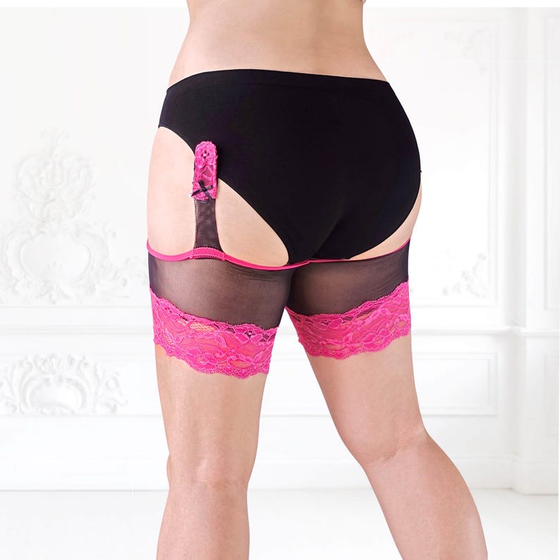Rear view of model in BaeBliss anti-chafing thigh bands featuring hot pink lace hems, showing coverage and fit from slightly side-on angle.