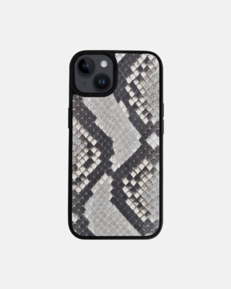 May include: A black phone case with a gray and black snake skin pattern.