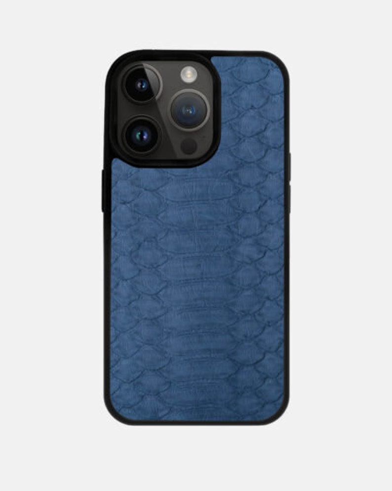 May include: A blue phone case with a textured, snake-skin pattern.