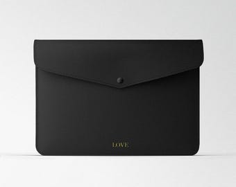 May include: Black leather envelope clutch with a gold embossed "LOVE" on the front.