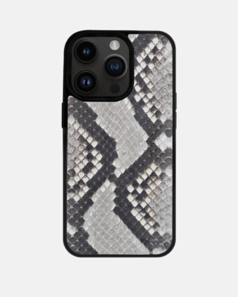 May include: A black phone case with a snakeskin pattern in shades of gray and black.