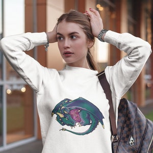 May include: White sweatshirt with a green dragon curled around a purple and white dice. The dragon has yellow accents and a green and purple tail.