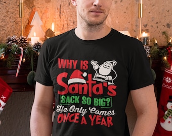 May include: A black t-shirt with a red and green graphic that says "Why is Santa's sack so big? He only comes once a year".