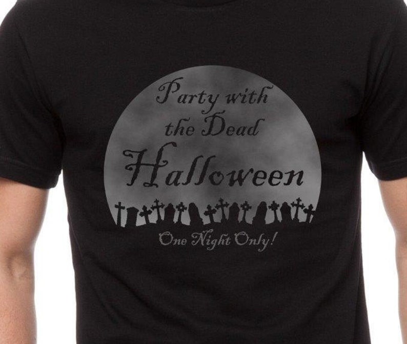 May include: Black t-shirt with a graphic of a full moon and the text "Party with the Dead Halloween One Night Only!" with a row of tombstones at the bottom.