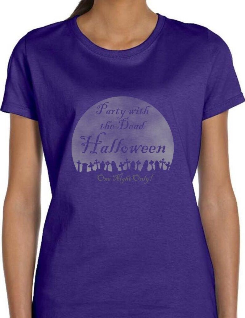 May include: Purple t-shirt with a white graphic of a moon with the text "Party with the Dead Halloween One Night Only!"