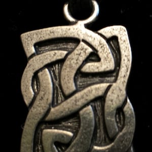 May include: A silver Celtic knot pendant with a black leather cord.