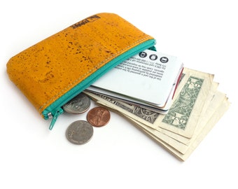 Small leather pouch made from cork fabric. Zippered change purse. Mustard yellow.