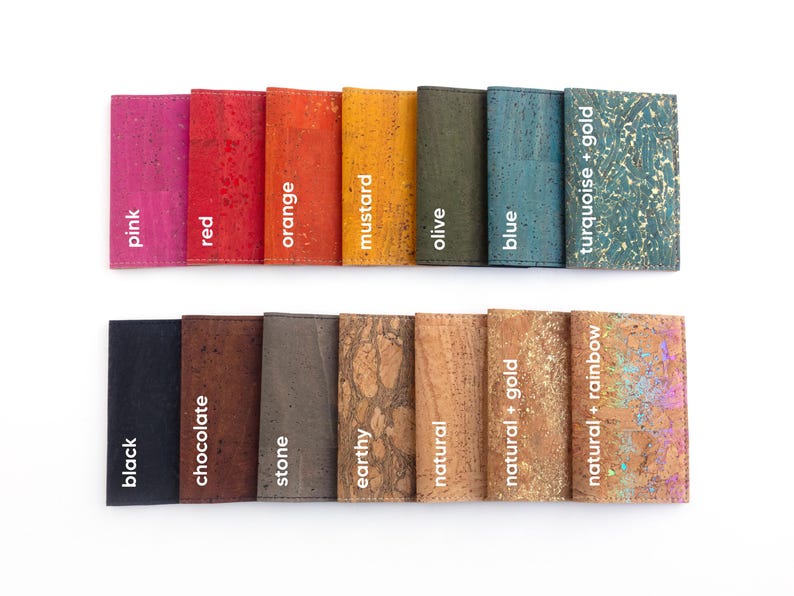 Pu&ograve; includere: Una collezione di portafogli in sughero in vari colori, tra cui rosa, rosso, arancione, senape, oliva, blu e turchese con dettagli dorati. Altri colori sono nero, cioccolato, pietra, terroso, naturale e naturale con dettagli oro e arcobaleno. Ogni portafoglio &egrave; etichettato.