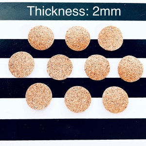 May include: Ten round cork circles, each measuring 2 mm thick, arranged in three rows on a black and white striped background. The text "Thickness: 2mm" is printed above the cork circles.